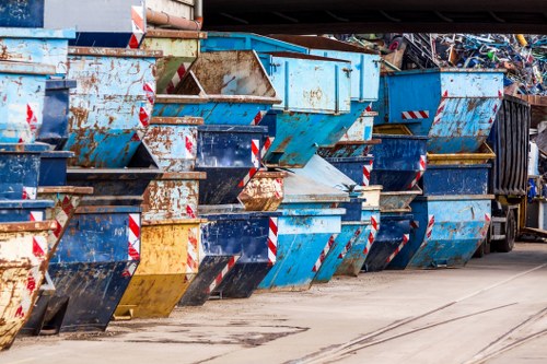 Workers sorting items from a flat clearance into recycling and donation piles